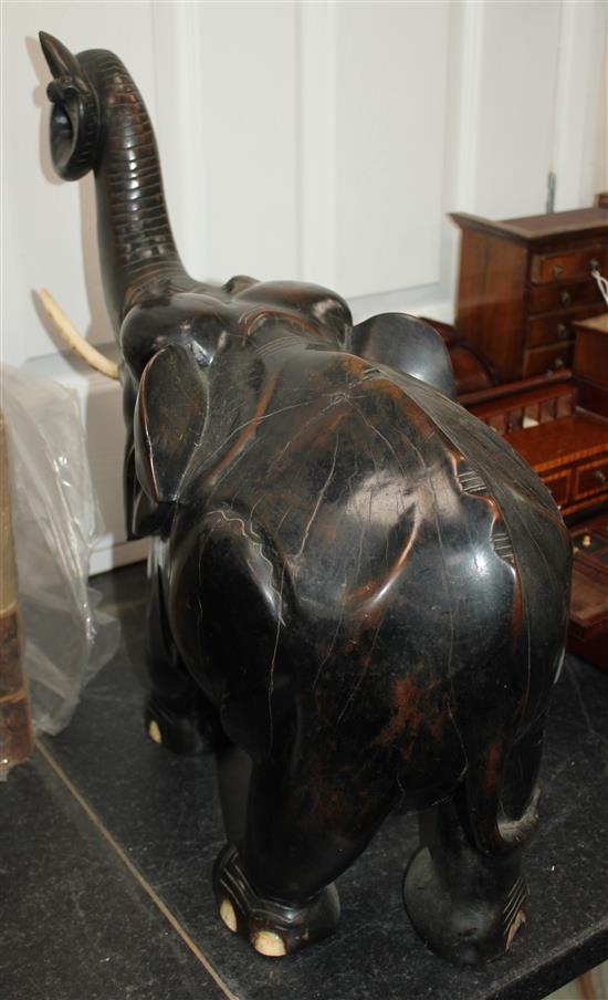 A large Indian ebonised carved hardwood elephant, 21in.